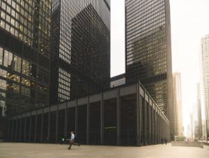 Man running through Toronto's Financial District, in a hurry to do some Canadian business banking