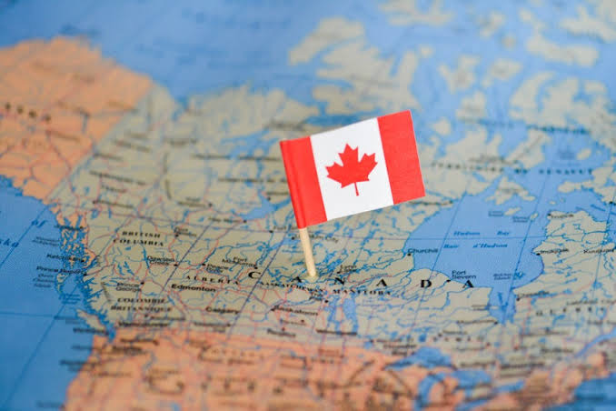 Canadian flag on a map of Canada as the departure point for a vacation
