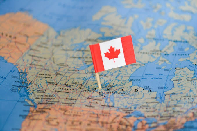 Canadian flag on a map of Canada as the departure point for a vacation